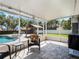 Relaxing screened-in patio with tile flooring, outdoor furniture, and a view of the backyard pool and gazebo at 1189 Lazy Hollow Pl, Winter Park, FL 32792