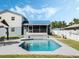 View of the in-ground pool showcasing screened lanai and beautiful tiling detail at 1189 Lazy Hollow Pl, Winter Park, FL 32792