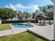 Backyard swimming pool with chairs and umbrellas, accented by a wooden gazebo at 1189 Lazy Hollow Pl, Winter Park, FL 32792