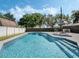 Sparkling pool with clear water and a patio area surrounded by a privacy fence and lush trees at 1189 Lazy Hollow Pl, Winter Park, FL 32792