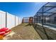 Large backyard featuring a play set and partial view of the screened-in pool area at 121 Sonja Cir, Davenport, FL 33897