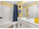 Bright bathroom features white fixtures, tiled shower, and updated vanity with ample counter space at 121 Sonja Cir, Davenport, FL 33897