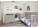 Bright bedroom featuring grey floors, a crib, toys, and natural light at 121 Sonja Cir, Davenport, FL 33897