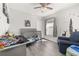 Adorable bedroom with stylish decor, including a crib, chair, and gray wood flooring at 121 Sonja Cir, Davenport, FL 33897