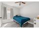 Bright bedroom with wood floors, ceiling fan, window, and bed with blue covers at 121 Sonja Cir, Davenport, FL 33897