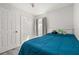 Comfortable bedroom featuring a window, closet, and plush blue bedcovers at 121 Sonja Cir, Davenport, FL 33897