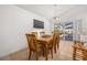 Bright dining room with backyard pool view, and a wooden dining set, perfect for Gathering meals and entertaining at 121 Sonja Cir, Davenport, FL 33897