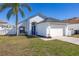 Well-maintained single-story home featuring a manicured lawn and driveway leading to an attached two-car garage at 121 Sonja Cir, Davenport, FL 33897