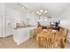 Kitchen and dining area with white cabinetry and open floor plan to living room at 121 Sonja Cir, Davenport, FL 33897