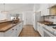 Bright kitchen features white cabinetry, tan countertops, and stainless steel sink at 121 Sonja Cir, Davenport, FL 33897