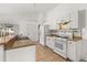 Bright kitchen featuring white cabinets, a tile backsplash, and modern appliances, offering a clean and functional space at 121 Sonja Cir, Davenport, FL 33897
