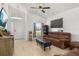 Inviting living room with vaulted ceilings, wood-look floors, ceiling fan and a comfortable leather sofa at 121 Sonja Cir, Davenport, FL 33897