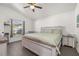 Comfortable main bedroom with a ceiling fan, neutral colors and ensuite bathroom at 121 Sonja Cir, Davenport, FL 33897
