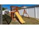 Backyard wooden playset with a slide and swing, perfect for outdoor fun and activities at 121 Sonja Cir, Davenport, FL 33897