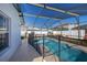 Sparkling screened-in pool with crystal blue water, seating, and a secure safety fence at 121 Sonja Cir, Davenport, FL 33897