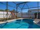 Inviting screened pool with a playset, perfect for backyard enjoyment and entertaining at 121 Sonja Cir, Davenport, FL 33897