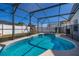 Sparkling screened-in pool with play set creates a fun outdoor oasis for relaxation and recreation at 121 Sonja Cir, Davenport, FL 33897