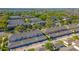 Aerial view of townhomes with attached garages in a leafy neighborhood near a lake at 14433 Pleach St, Winter Garden, FL 34787