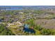 Aerial view showcasing the community with pools, townhomes and lush landscaping by the lake at 14433 Pleach St, Winter Garden, FL 34787