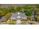 Aerial view of community clubhouse with pool, parking, and green landscaping near a wooded area at 14433 Pleach St, Winter Garden, FL 34787