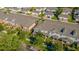Aerial view of a residential community showcasing roof lines and street layout amidst green landscaping at 14433 Pleach St, Winter Garden, FL 34787