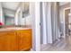 Bathroom featuring a wood vanity, neutral walls, and a shower with a white curtain at 14433 Pleach St, Winter Garden, FL 34787