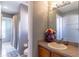 Bathroom featuring a sink vanity with mirror and view to a shower-tub combo with shower curtain at 14433 Pleach St, Winter Garden, FL 34787