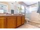 Bathroom with double sink vanity, tile floor, and glass door walk-in shower at 14433 Pleach St, Winter Garden, FL 34787