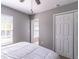 Cozy bedroom with a window, double-door closet, and a partial view of an adjacent room at 14433 Pleach St, Winter Garden, FL 34787