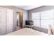 Bright bedroom featuring a closet, window with blinds, and a glimpse into an en-suite bathroom at 14433 Pleach St, Winter Garden, FL 34787