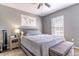 Bedroom featuring a ceiling fan, window with blinds, and a queen bed with a cushioned bench at 14433 Pleach St, Winter Garden, FL 34787