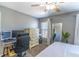 Bedroom features a desk area, large dresser, and a queen bed with natural light from the window at 14433 Pleach St, Winter Garden, FL 34787