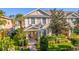 Charming two-story townhome featuring a well-manicured lawn and inviting covered entryway at 14433 Pleach St, Winter Garden, FL 34787
