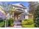 Charming two-story townhome with a brick walkway and manicured front lawn and garden at 14433 Pleach St, Winter Garden, FL 34787