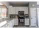 Kitchen featuring stainless appliances, granite counters, and bright white cabinets at 14433 Pleach St, Winter Garden, FL 34787