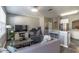 Open-concept living area with gray walls, recessed lights, and stylish furnishings at 14433 Pleach St, Winter Garden, FL 34787