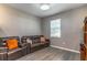 Cozy living room featuring new LVP flooring, neutral paint, and lots of natural light at 14433 Pleach St, Winter Garden, FL 34787