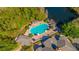 Aerial view of a beautiful community pool with lounge chairs and landscaping by a pond at 14433 Pleach St, Winter Garden, FL 34787