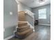 Carpeted staircase with gray walls, white trim, and wood-look floors leading to a sitting area at 14433 Pleach St, Winter Garden, FL 34787