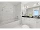 Spa-like bathroom with a soaking tub, dual sinks, modern fixtures, and white marble tile at 150 E Robinson St # 2608, Orlando, FL 32801