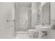 Elegant bathroom featuring a glass-enclosed shower with marble tile, a white pedestal sink, and modern fixtures at 150 E Robinson St # 2608, Orlando, FL 32801