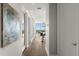 Bright hallway with hardwood floors leading to an open-plan living space with floor to ceiling windows and city view at 150 E Robinson St # 2608, Orlando, FL 32801