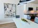 Bright kitchen area with white cabinetry, stainless steel appliances, modern lighting, and an abstract art piece at 150 E Robinson St # 2608, Orlando, FL 32801