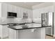 Well-equipped kitchen with black countertops, stainless steel appliances, and white cabinets at 150 E Robinson St # 2608, Orlando, FL 32801
