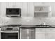 Close-up of the gourmet kitchen featuring stainless steel appliances and sleek white cabinetry at 150 E Robinson St # 2608, Orlando, FL 32801