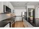 Well-equipped kitchen with granite counters, stainless steel appliances, white cabinets, and hardwood flooring at 150 E Robinson St # 2608, Orlando, FL 32801