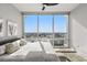 Bright bedroom with a large window showcasing city views, complemented by hardwood floors and neutral decor at 150 E Robinson St # 2608, Orlando, FL 32801
