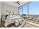 Serene bedroom featuring a large window with stunning city views, hardwood floors, and soft, neutral decor at 150 E Robinson St # 2608, Orlando, FL 32801