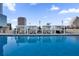 Luxurious rooftop pool with lounge chairs, private cabanas, and city views at 150 E Robinson St # 2608, Orlando, FL 32801