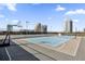 Rooftop tennis court with basketball hoops and city views offers recreational opportunity for residents at 150 E Robinson St # 2608, Orlando, FL 32801